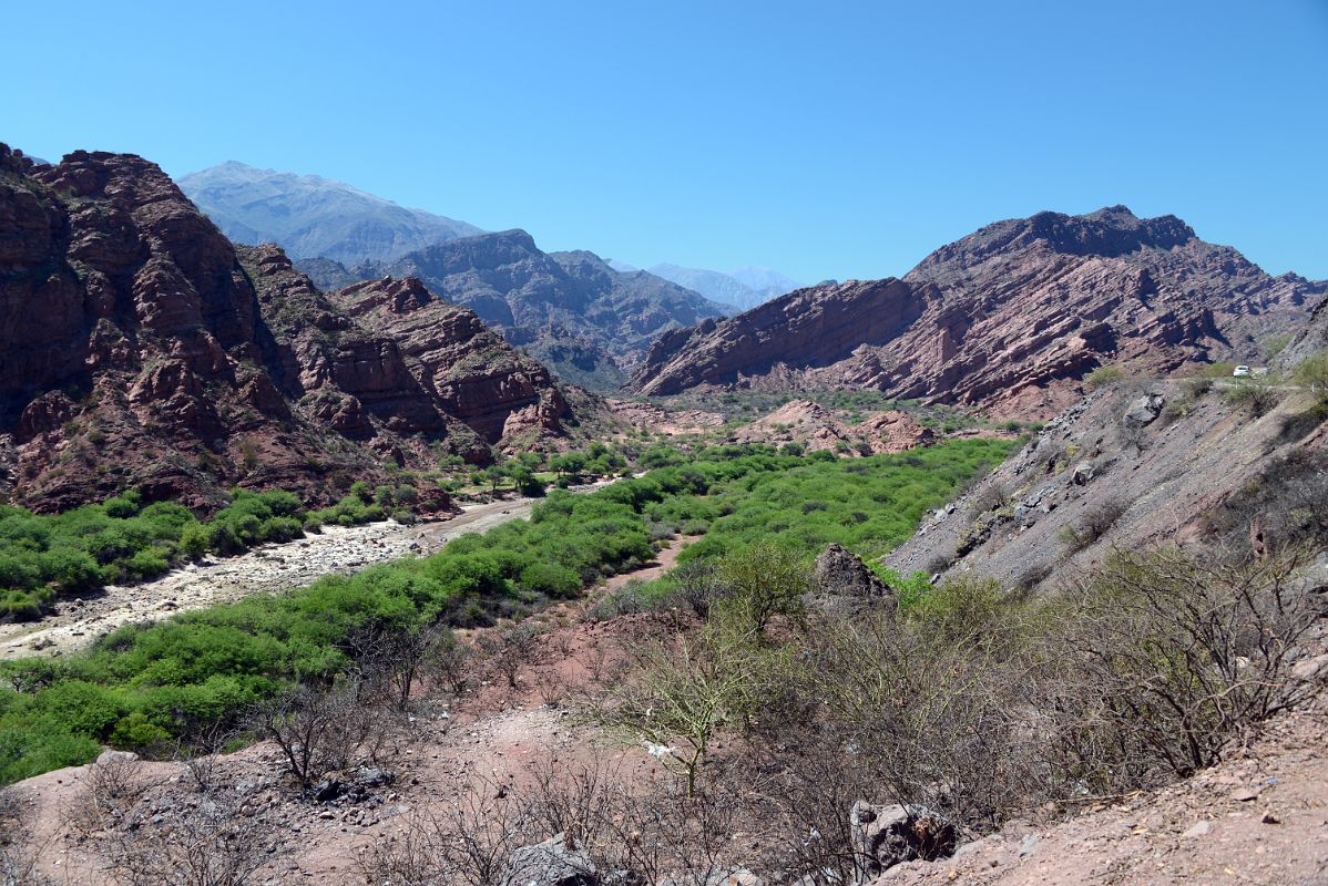 06 Our First Stop View Of River Flowing Through A Fertile Valley With Eroded Red Hills In Quebrada de Cafayate South Of Salta